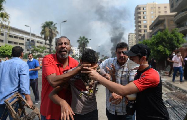 Au Caire, des partisans de Morsi fuient les gaz lacrymogènes, le 14 août 2013. Au Caire, des partisans de Morsi fuient les gaz lacrymogènes, le 14 août 2013.
