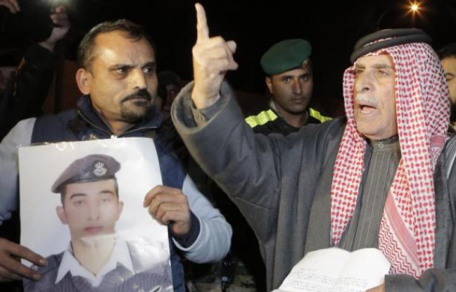 Le père d'un pilote jordanien menacé de mort par l'EI brandit sa photo le 28 janvier 2015 à Amman Le père d'un pilote jordanien menacé de mort par l'EI brandit sa photo le 28 janvier 2015 à Amman