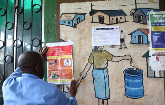 Au Liberia, un infirmier lit les recommandations concernant les précautions à prendre pour lutter contre le virus Ebola, le 30 juillet 2014 Au Liberia, un infirmier lit les recommandations concernant les précautions à prendre pour lutter contre le virus Ebola, le 30 juillet 2014
