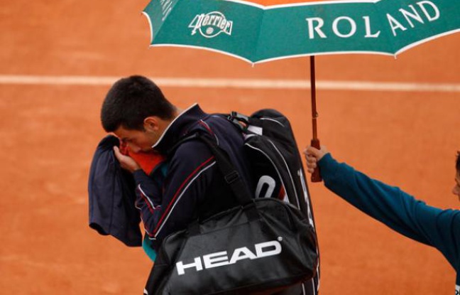 Novak quitte le court de la finale de Roland-Garros sous la pluie, le 10 juin 2012. Novak quitte le court de la finale de Roland-Garros sous la pluie, le 10 juin 2012.