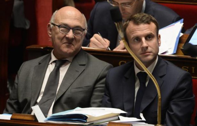 Le ministre des Finances Michel Sapin et le ministre de l'Economie Emmanuel Macron le 28 octobre 2014 à l'Assemblée nationale à Paris Le ministre des Finances Michel Sapin et le ministre de l'Economie Emmanuel Macron le 28 octobre 2014 à l'Assemblée nationale à Paris