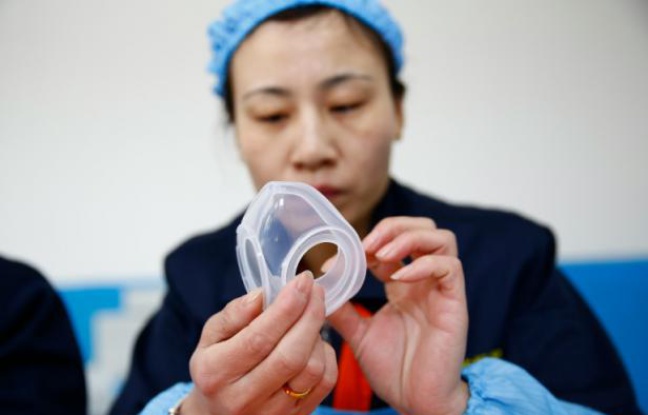 Une employée de l'usine ASL qui fabrique des masques antipollution à Dongliu dans la province de Shandong en Chine, le 27 janvier 2016 Une employée de l'usine ASL qui fabrique des masques antipollution à Dongliu dans la province de Shandong en Chine, le 27 janvier 2016