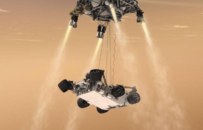 Vue d'artiste du robot Curiosity, un rover de la taille d'une voiture, qui doit être hélitreuillé jusqu'à la surface de Mars le 6 août 2012. Vue d'artiste du robot Curiosity, un rover de la taille d'une voiture, qui doit être hélitreuillé jusqu'à la surface de Mars le 6 août 2012.