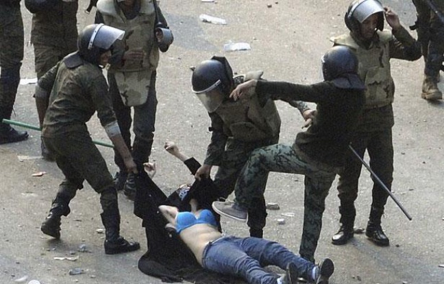 Des soldats égyptiens arrêtent une manifestante lors d'affrontement place Tahrir, au Caire, le 17 décembre 2011. Des soldats égyptiens arrêtent une manifestante lors d'affrontement place Tahrir, au Caire, le 17 décembre 2011.