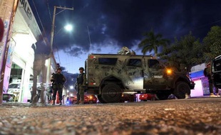 Des soldats mexicains gardent l'accès à la morgue où est conservé la dépouille supposée de Nazario Moreno, dit "El Chayo", à Apatzingan le 9 mars 2014