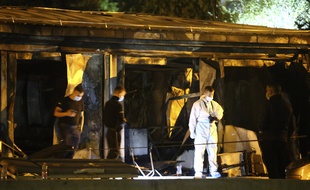 Des policiers et des pompiers inspectent les décombres d'un hôpital à Tetovo, en Macédoine du Nord, après un incendie le 8 septembre 2021.