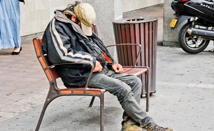 Un sans domicile fixe dort dans la rue.