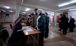 Des électeurs dans un bureau de vote le 16 mars 2014 à Simféropol