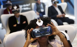 Yasmin Moorman looks into the Galaxy Gear VR headset at the Samsung booth during the International CES, Tuesday, Jan. 6, 2015, in Las Vegas. (AP Photo/John Locher)/NVJL122/579514850490/1501070045