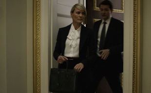 Claire Undewood porte un sac de jour et une blouse Hedi Slimane pour Saint Laurent.