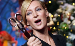 U.S. actress Uma Thurman poses with the scissors used to cut the red ribbon during the unveiling of a Christmas-themed shop window displayed at Le Printemps department store in Paris, Thursday Nov. 3, 2016. (AP Photo/Francois Mori)/ZFM114/16308639352149/1611031849
