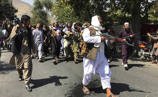 Des soldats talibans se dirigent vers des Afghans en criant des slogans, lors d'une manifestation anti-pakistanaise, près de l'ambassade du Pakistan à Kaboul, en Afghanistan, le mardi 7 septembre 2021.