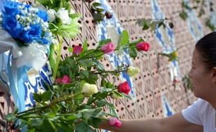 Une Thaïlandaise dépose des roses sur le monument Ban Nam Khem en mémoire aux victimes du Tsunami, dans la province de Phang-nga en Thaïlande, le 26 décembre 2014