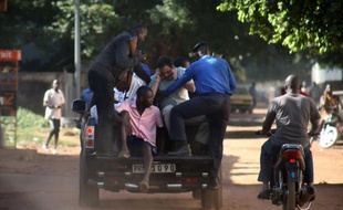 Des forces de sécurité maliennes évacuent des otages sortis de l'hôtel Radisson, le 20 novembre 2015 à Bamako