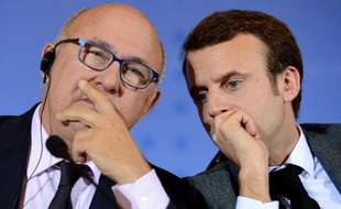 Les ministres des Finances Michel Sapin (g) et de l'Economie Emmanuel Macron, le 2 décembre 2014
