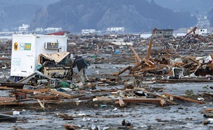 Un homme fouille les ruines à la recherche de souvenirs de sa femme disparue dans le séisme, le 13 mars 2011 à Rikuzentakada, dans le nord du Japon.