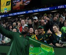 South Africa's Siya Kolisi takes photos with fans after the Rugby Championship match between Australia and South Africa at Allianz Stadium in Sydney on September 3, 2022. (Photo by SAEED KHAN / AFP) / -- IMAGE RESTRICTED TO EDITORIAL USE - STRICTLY NO COMMERCIAL USE --