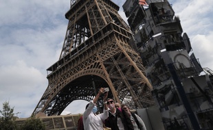 Des touristes devant la Tour Eiffel, à Paris le 15 juillet 2020.