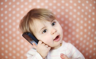 Un enfant d'un an avec un téléphone.