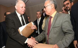 Le vice-président du Parlement de Tripoli non reconnu par la communauté internationale, Awad Mohammed Abdoul-Sadiq (G) et Ibrahim Fethi Amish de la Chambre des représentants de Libye, reconnu par la communauté internationale, après la signature d'un accord en vue d'un règlement politique du conflit, le 6 décembre 2015 à Tunis