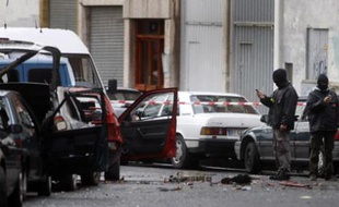 Basque policemen collect evidence in front of the Basque Socialist Party (PSE) office in the La Pena district, Bilbao April 17, 2008, where a bomb exploded early Thursday. Seven police officers who had cordoned off the area after a warning from ETA suffered light injuries when the bomb exploded. REUTERS/Vincent West (SPAIN)