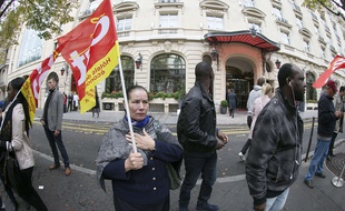 Members of the CGT union gather on October 7, 2014 in front of the Royal Monceau hotel, whose employees have been on strike since October 2, in Paris. The staff of the 5-star hotel demand a salary on par with what is the norm in other luxury establishments. AFP PHOTO / JOEL SAGET