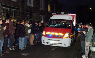 Students applaud as they look at an ambulance carrying a wounded student after clashes between students and policemen, 27 November 2007 in Nantes, western France, during a demonstration to protest against Pecress law on universities reforms. Students demonstrate against the education reforms adopted this summer and that grant more autonomy to universities by allowing them to seek private funding and develop closer ties with businesses.