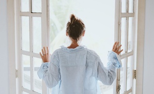 Illustration d'une femme qui aère sa chambre.
