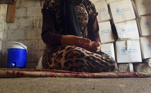 FILE - In this file photo taken Wednesday, Oct. 8, 2014, a 15-year-old Yazidi girl captured by the Islamic State group and forcibly married to a militant in Syria sits on the floor of a one-room house she now shares with her family after escaping in early August, while speaking in an interview with The Associated Press in Maqluba, a hamlet near the Kurdish city of Dahuk, 260 miles (430 kilometers) northwest of Baghdad, Iraq. Hundreds of women have been captured by the group, enslaved and sold, many have been subjected to sexual violence and others have been stoned for adultery. (AP Photo/Dalton Bennett, File)/CAINM501/295523838096/FILE PHOTO TAKEN WEDNESDAY, OCT. 8, 2014. THE GIRL IS NOT IDENTIFIED DUE TO ABUSE AND HER FEAR OF REPRISALS AGAINST HER RELATIVES STILL BEING HELD BY ISLAMIC STATE MILITANTS./1412230649