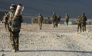 Un soldat français du 13e bataillon de chasseurs alpins en patrouille transporte un tapis afghan, Tagab, Afghanistan, le 7 janvier 2010.