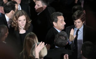 Former French president Nicolas Sarkozy (2ndR) arrives to attend a meeting of French right-wing UMP party candidate for the March 2014 mayoral elections Nathalie Kosciusko-Morizet (behind him) in Paris, at the Gymnase Japy in Paris, on February 10, 2014. AFP PHOTO / JACQUES DEMARTHON
