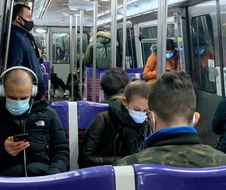 Commuters sit in a train on the line 13 of the Parisian underground in Paris, on November 4, 2020, on the sixth day of a lockdown aimed at containing the spread of the Covid-19. (Photo by Martin BUREAU / AFP)