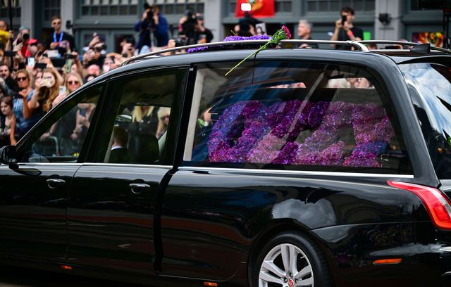 Le corbillard, en tête, transportait le cercueil de l’artiste orné de fleurs pourpres formant « Ozzy », le nom de scène de celui qui se prénommait John Michael à l’état civil.