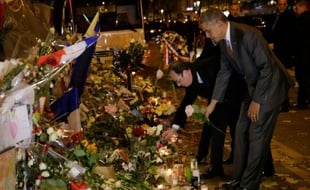 Les présidents français François Hollande et américain Barack Obama, se recueillent une rose blanche à la main, devant le Bataclan le 30 novembre 2015 à Paris