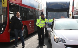Un policier devant un bus à Londres (illustration).