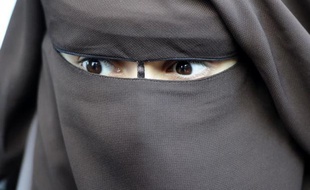 Hind Ahmas, attends a press conference on December 12, 2011 in front of the police tribunal in Paris, after being fined for violating France's niqab ban. In France, a woman who repeatedly insists on appearing veiled in public can be fined 150 euros and ordered to attend re-education classes. AFP PHOTO / MIGUEL MEDINA