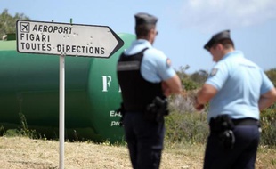 Des policiers en faction sur une route le 28 avril 2014 après l'assassinat d'un promoteur immobilier de 41 ans, Guy Casanova, tué par balles lundi près de Figari dans l'extreme sud de la Corse