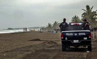 Des policiers sur la plage de Boca de Pascuales, au Mexique, le 22 octobre 2015.