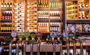 Illustration de multiples alcools dans un bar.