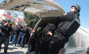 Tunisian policemen secure the Bardo museum are evacuated in Tunis, Wednesday, March 18, 2015 in Tunis, Tunisia after gunmen opened fire at the leading museum in Tunisia's capital. Tunisia's prime minister says 21 people are dead after an attack on a major museum, including 17 foreign tourists and that two or three of the attackers remain at large/HAMMI_1730.08/Credit:MOHAMED HAMMI/SIPA/1503181740