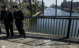 Des policiers égyptiens en faction à l'endroit où une bombe a tué un agent le 5 avril 2015, sur le Pont du 15 mai qui enjambe le Nil au Caire