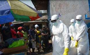 Des employés de la Croix Rouge transportent des corps de victimes d'Ebola, le 5 janvier 2015 à Monrovia au Libéria