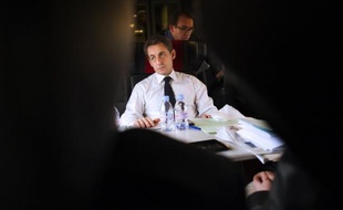 France's President and France's ruling party UMP candidate for the 2012 presidential election, Nicolas Sarkozy, is pictured in a train on his way from Paris to Lille, northern France, on February 23, 2012, for a campaign meeting. AFP PHOTO POOL / LIONEL BONAVENTURE