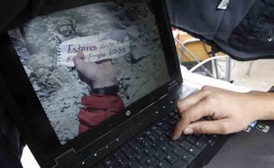 Un journaliste regarde l'image d'une note envoyée par l'un des 33 mineurs coincés dans une mine à Copiapo au Chili, le 23 août 2010.