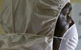 Un employé sanitaire portant un masque de protection participe à un exercice d'alerte à Monrovia, le 29 août 2014