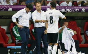 Le sélectionneur de l'Allemagne, Joachim Low, et son adjoint Hansi Flick, donnent leurs consignes à Mesut Ozil, le 27 juin 2012 à Varsovie.