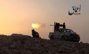Image tirée d'une vidéo diffusée le 10 octobre 2014 par Aamaq News Agency sur YouTube montrant des combattants du groupe Etat Islamique faisant feu depuis un pick-up sur les environs de Kobané, en Syrie