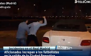 Des supporters du Real Madrid s'en prennent aux voitures des joueurs, le 23 mars 2015, à Madrid.