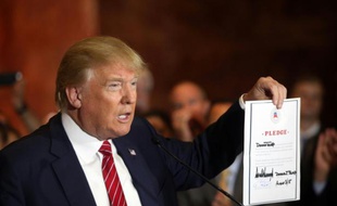 Le milliardaire Donald Trump, candidat républicain à la présidence américaine montre la promesse signée de soutenir le candidat choisi par le parti, lors d'une conférence de presse, le 3 septembre 2015 à New York