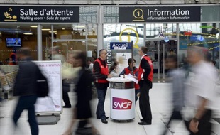 Des employés de la SNCF tiennent un point assistance dans une gare parisienne le 19 juin 2014
